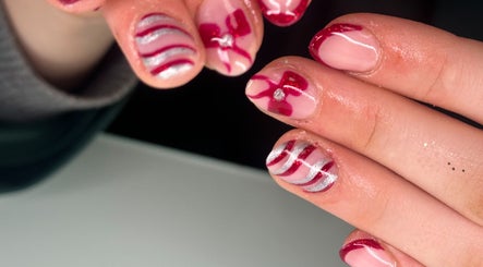 Artistic nail design at Beauty by Chloe Louise in Castlewellan, Northern Ireland, GB showcases red accents.