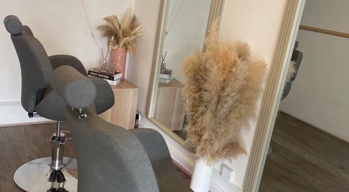 Elegant salon setup at Emmys Extensions in Garforth, England, GB, featuring stylish chairs and mirror.