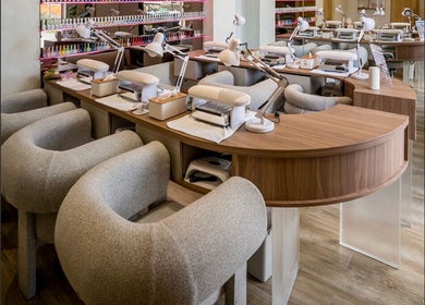 Elegant nail stations at Nail Lesss in Bali, Bali, ID, featuring plush chairs and modern equipment.