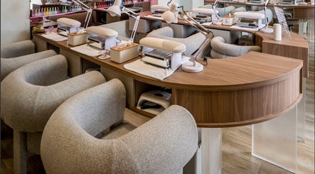 Elegant nail stations at Nail Lesss in Bali, Bali, ID, featuring plush chairs and modern equipment.