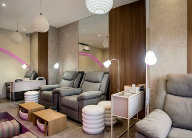 Relaxing pampering area at Nail Lesss Canggu, Bali, Bali, ID with plush seating and ambient lighting.