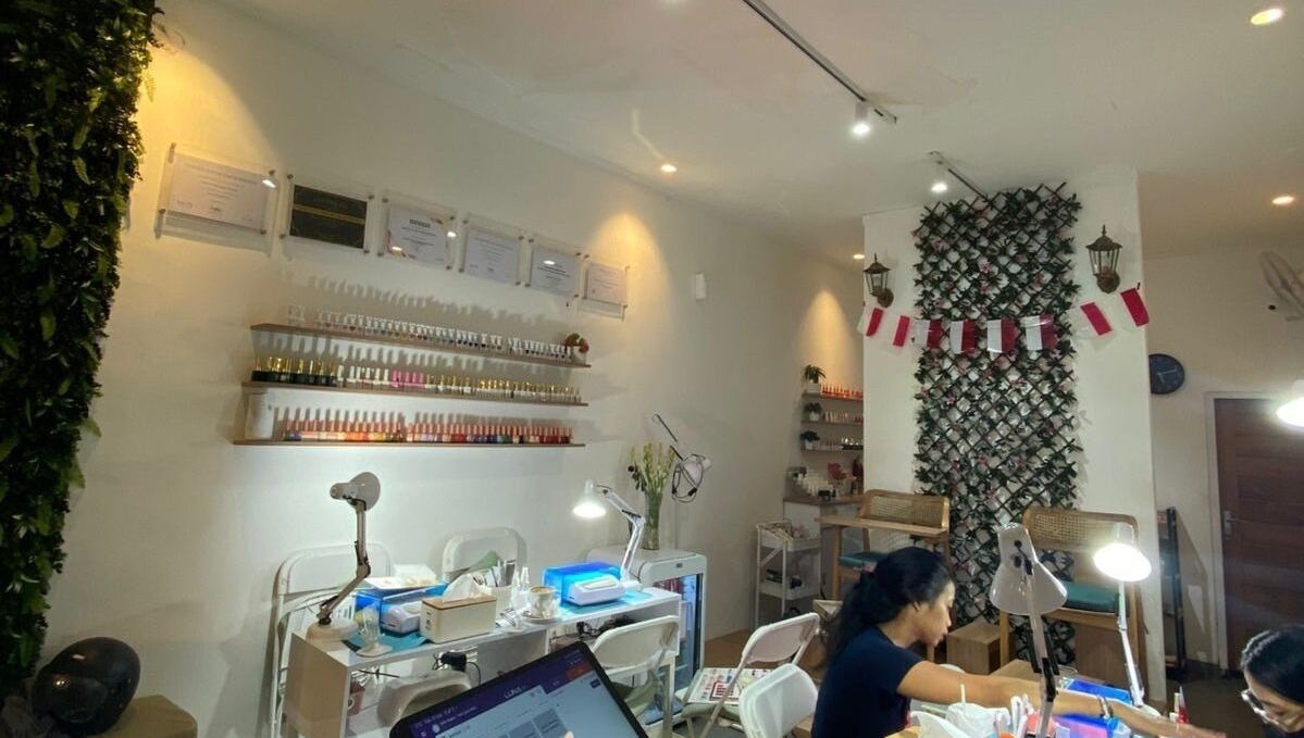 Nail Lesss Monkey Forest in Bali: Stylish nail salon interior with customer and manicure stations.