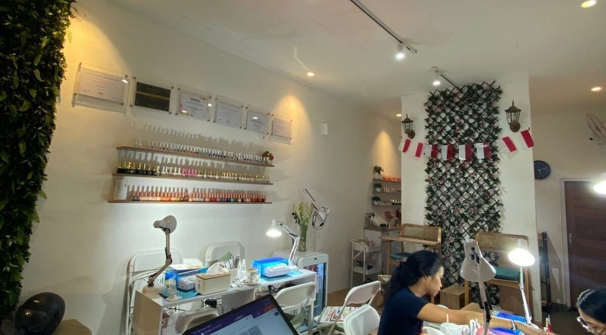 Nail Lesss Monkey Forest in Bali: Stylish nail salon interior with customer and manicure stations.
