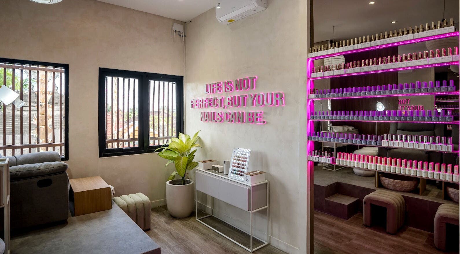 Interior of Nail Lesss Monkey Forest in Bali, featuring stylish decor, nail polish display, and relaxed seating.