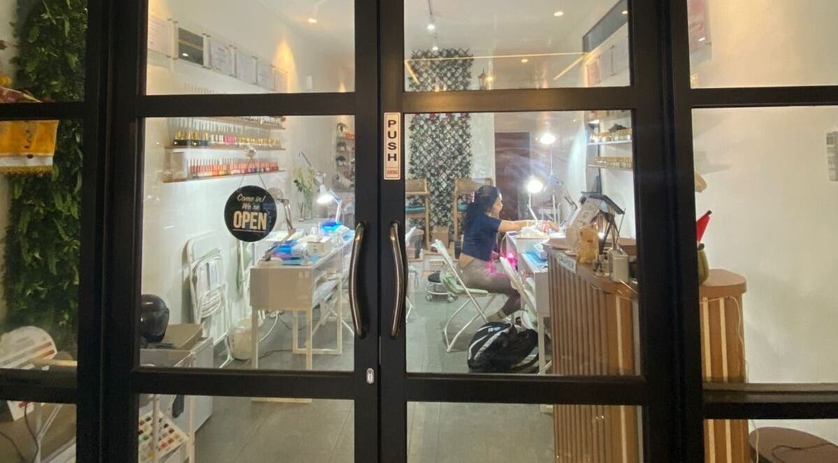 View through glass doors into Nail Lesss Monkey Forest salon in Bali, Bali, ID, showcasing a welcoming interior.