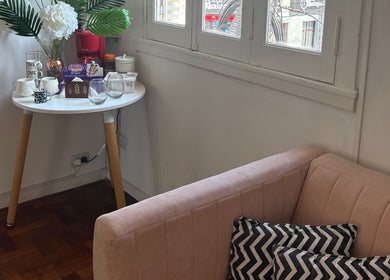 Cozy lounge with pink sofa and coffee setup at Ramos Beauty, Buenos Aires, Provincia De Buenos Aires, AR.