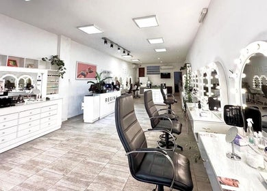 Interior of Regina La Plata in La Plata, Provincia De Buenos Aires, AR showcasing modern salon with styling stations.