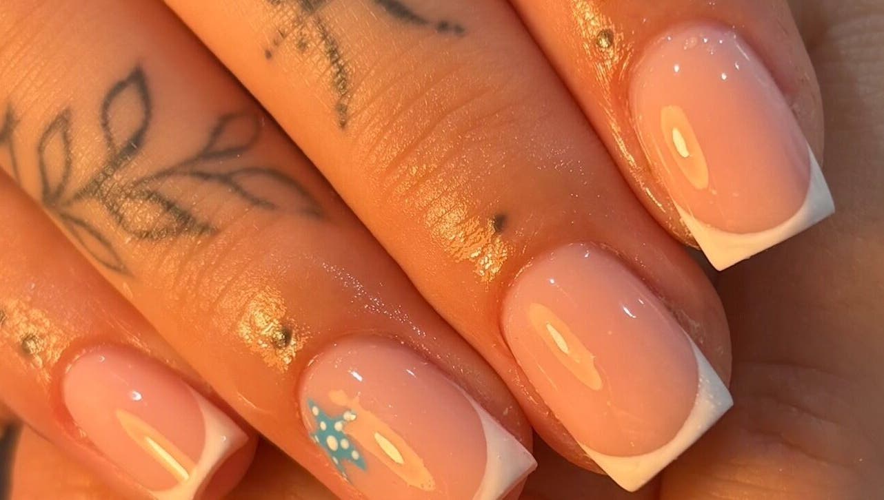French manicure with nail art at By Jess Ellis, Birkenhead, England, GB. Perfect for stylish nails.