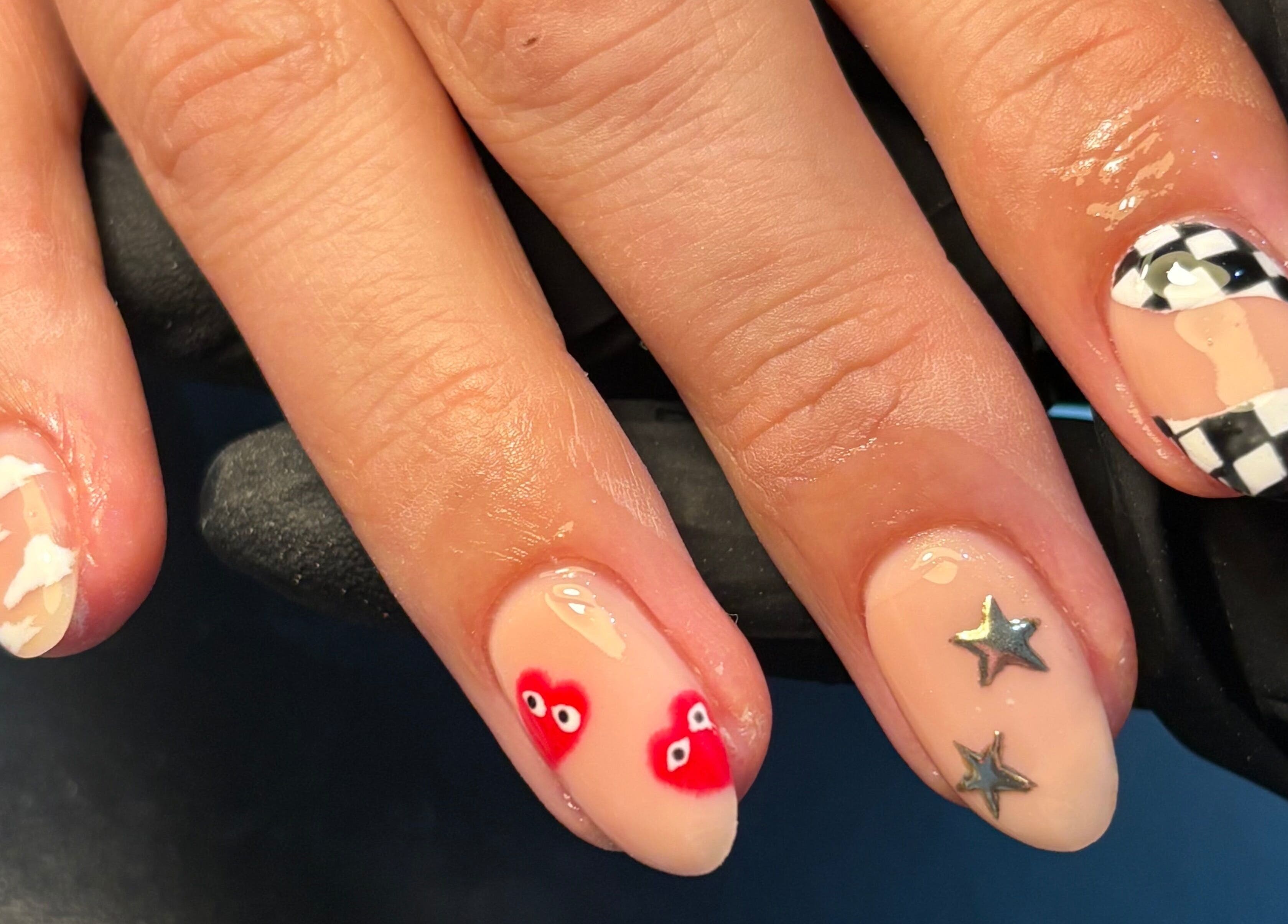 Stylish nail art design at By Jess Ellis, Birkenhead, England, GB featuring stars and hearts.