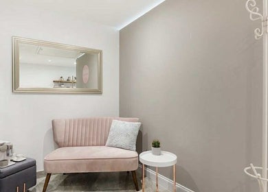 Stylish waiting area with pink velvet sofa at YM London, London, England, GB.