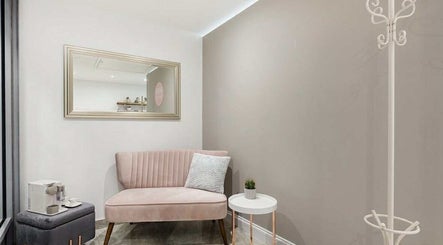 Stylish waiting area with pink velvet sofa at YM London, London, England, GB.