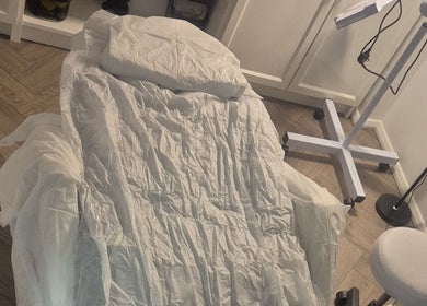 Comfortable treatment bed at YM London, London, England, GB, ready for beauty and wellness services.