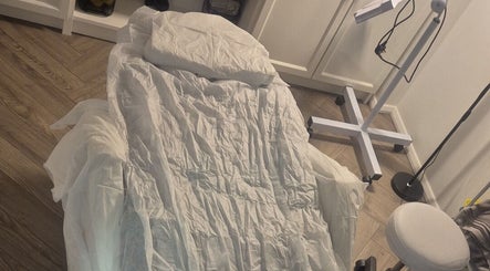 Comfortable treatment bed at YM London, London, England, GB, ready for beauty and wellness services.