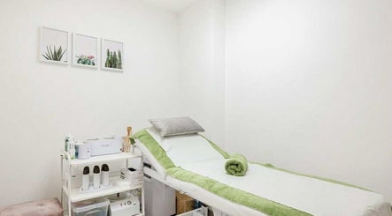 Calming treatment room at YM London Massage, London, England, GB, featuring a massage table and soft lighting.