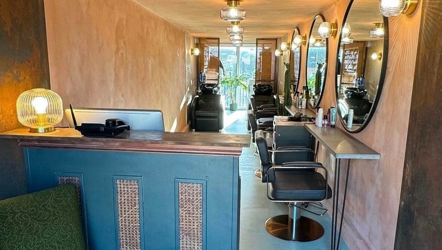 Cozy and elegant salon interior at Sher Arcana Studios, London, England, GB, featuring stylish decor and mirrors.