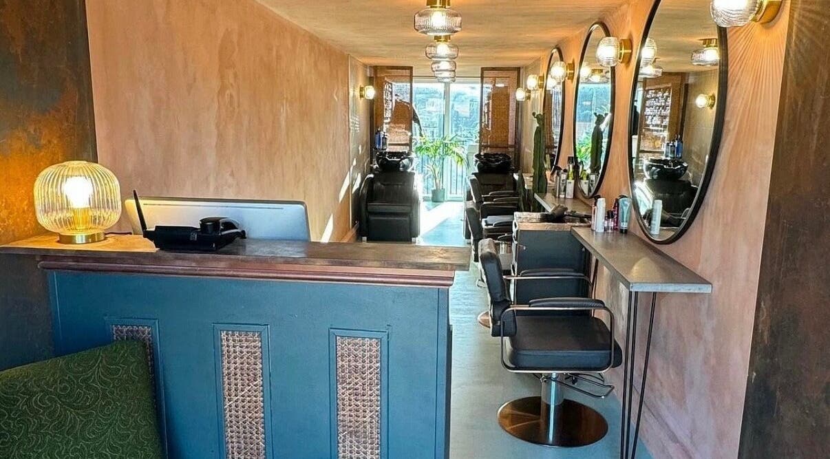 Cozy and elegant salon interior at Sher Arcana Studios, London, England, GB, featuring stylish decor and mirrors.