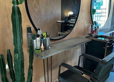 Chic salon station with mirror and styling products at Sher Arcana Studios, London, England, GB.
