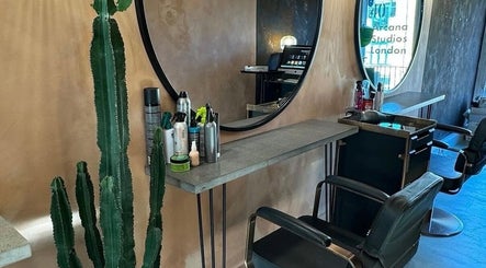 Chic salon station with mirror and styling products at Sher Arcana Studios, London, England, GB.