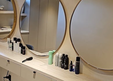 Chic vanity with round mirrors at Skin & Scalp, Mississauga, Ontario, CA, showcasing beauty products.