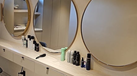 Chic vanity with round mirrors at Skin & Scalp, Mississauga, Ontario, CA, showcasing beauty products.