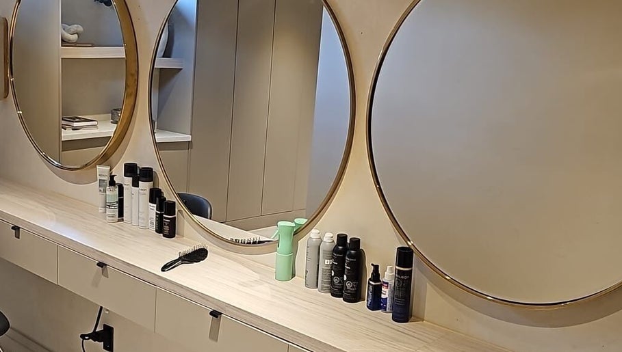 Stylish vanity setup at Skin & Scalp in Mississauga, Ontario, CA with beauty products and round mirrors.