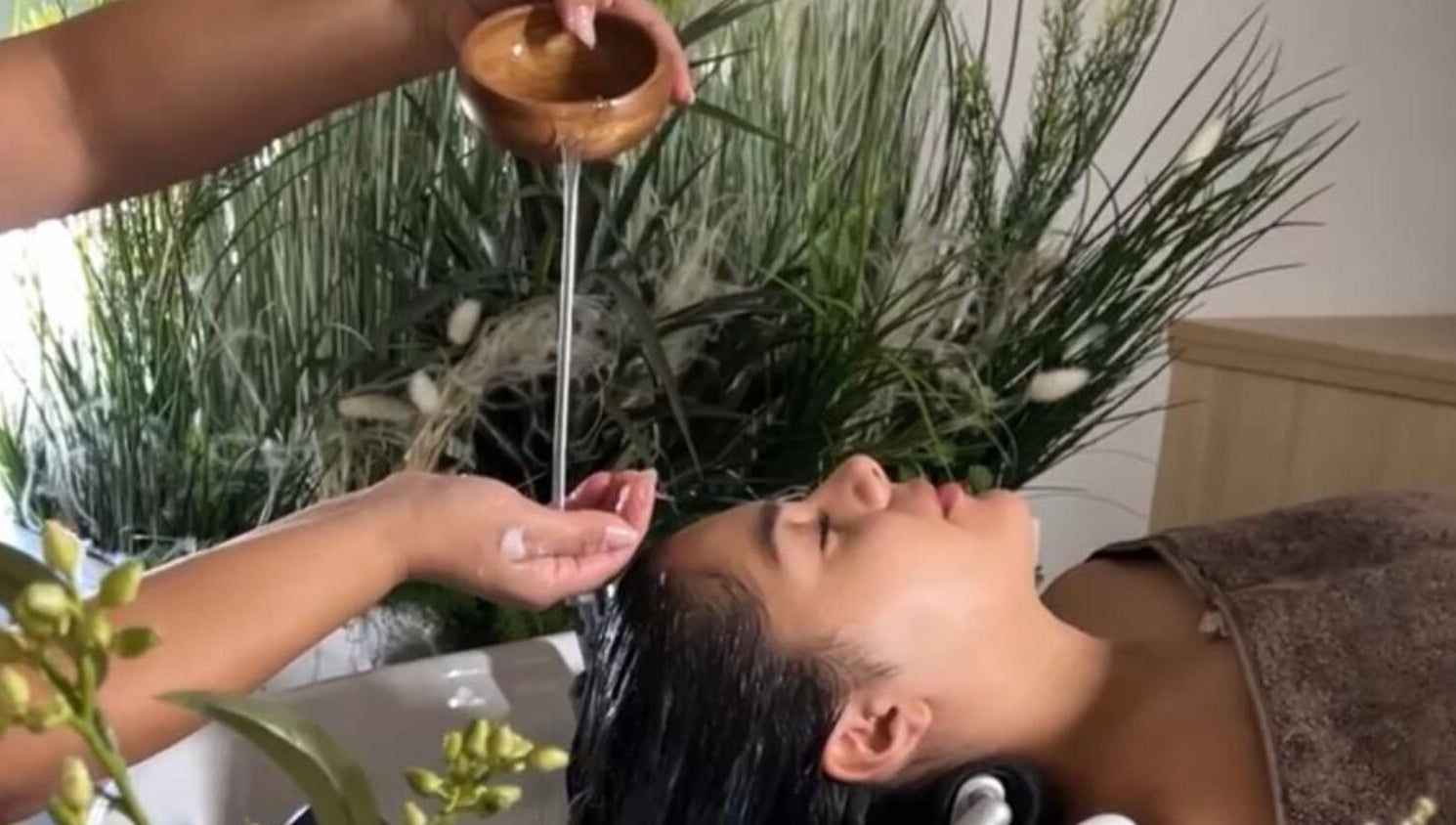 Relaxing hair treatment at Skin & Scalp, Mississauga, Ontario, CA with greenery in the background.