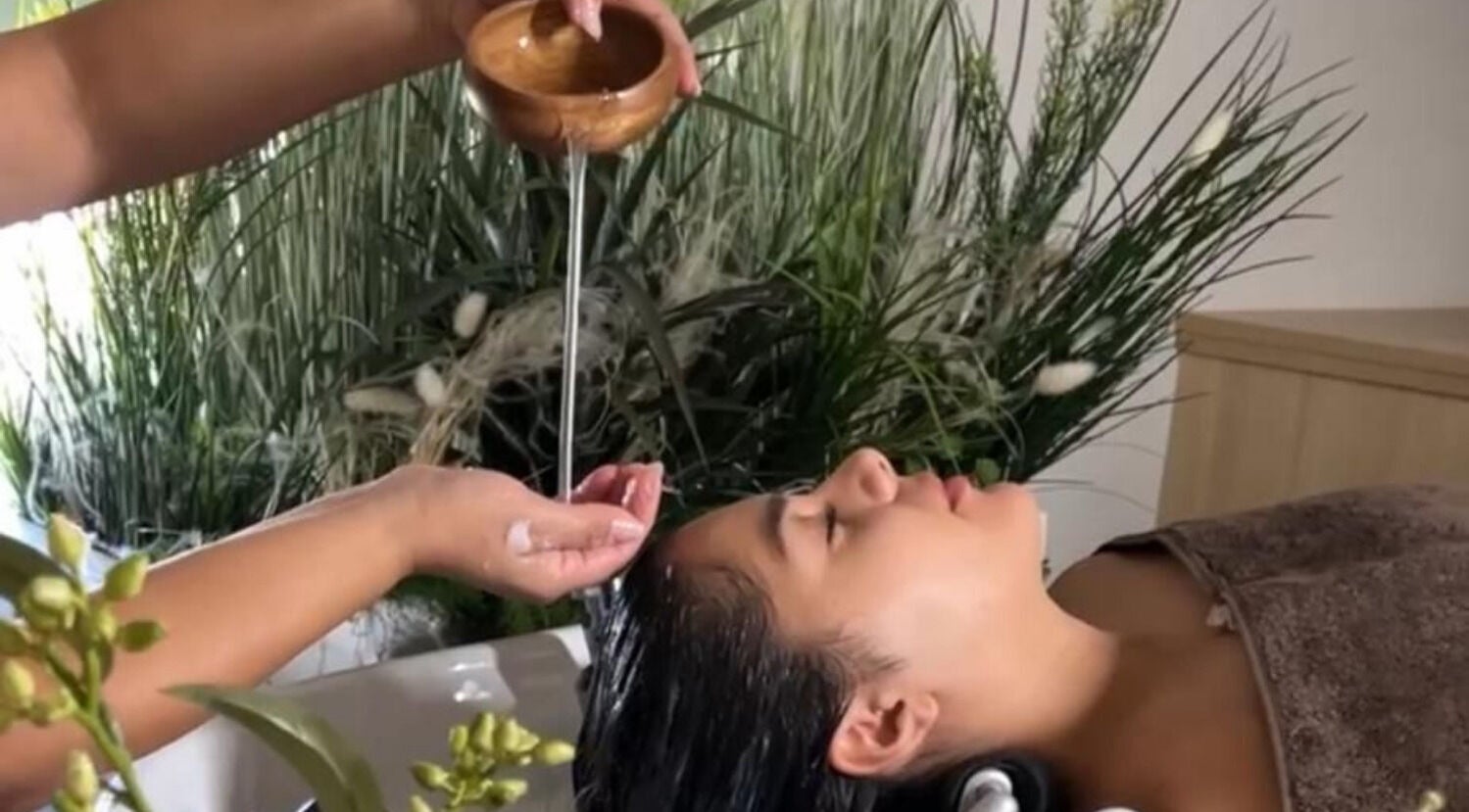 Relaxing hair treatment at Skin & Scalp, Mississauga, Ontario, CA with greenery in the background.