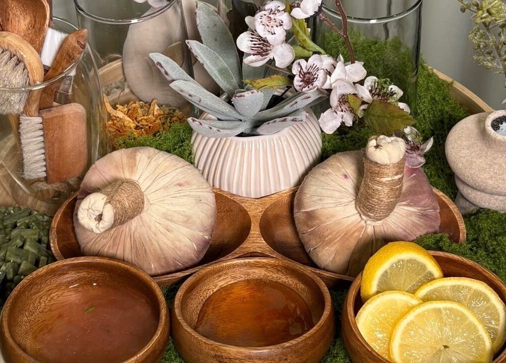 Relaxing spa essentials at Skin & Scalp, Mississauga, Ontario, CA. Wooden brushes, herbs, and citrus slices featured.