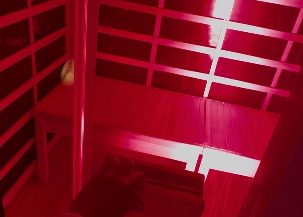 Infrared sauna with red lighting at Skin & Scalp, Mississauga, Ontario, CA, offers relaxation and wellness.