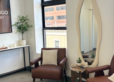 Relaxing lounge area at Bymilauryss, New Brunswick, New Jersey, US, featuring a leather chair and modern decor.