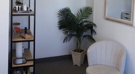 Cozy waiting area at Bymilauryss, New Brunswick, New Jersey, US, featuring a chic chair and elegant decor.