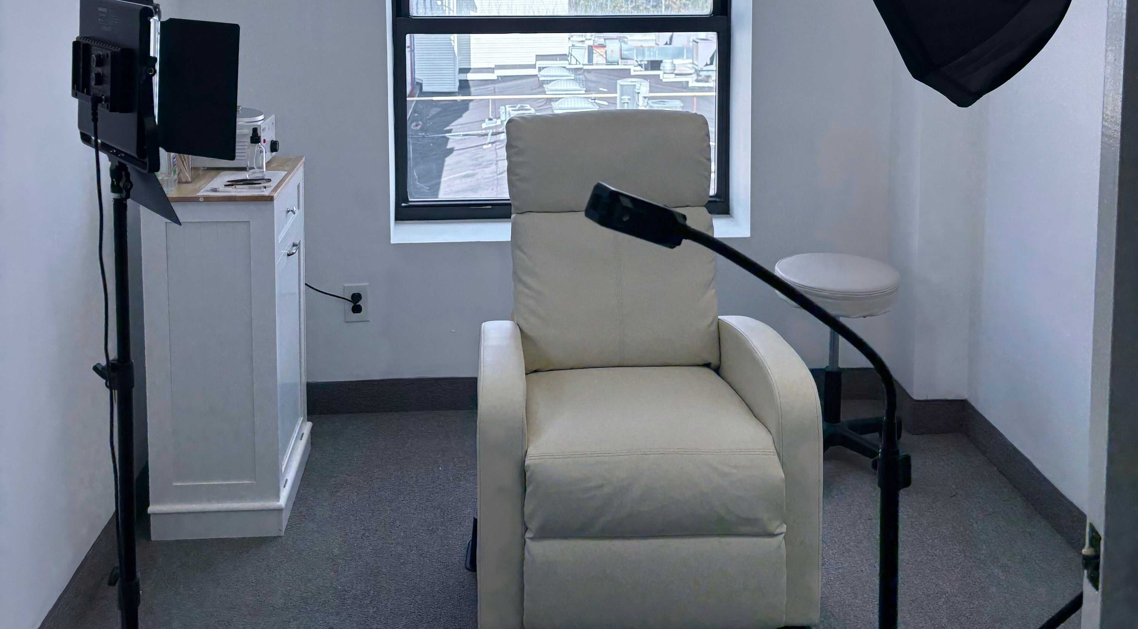 Elegant beauty lounge at Bymilauryss, New Brunswick, New Jersey, US, featuring a cream chair and minimal decor.