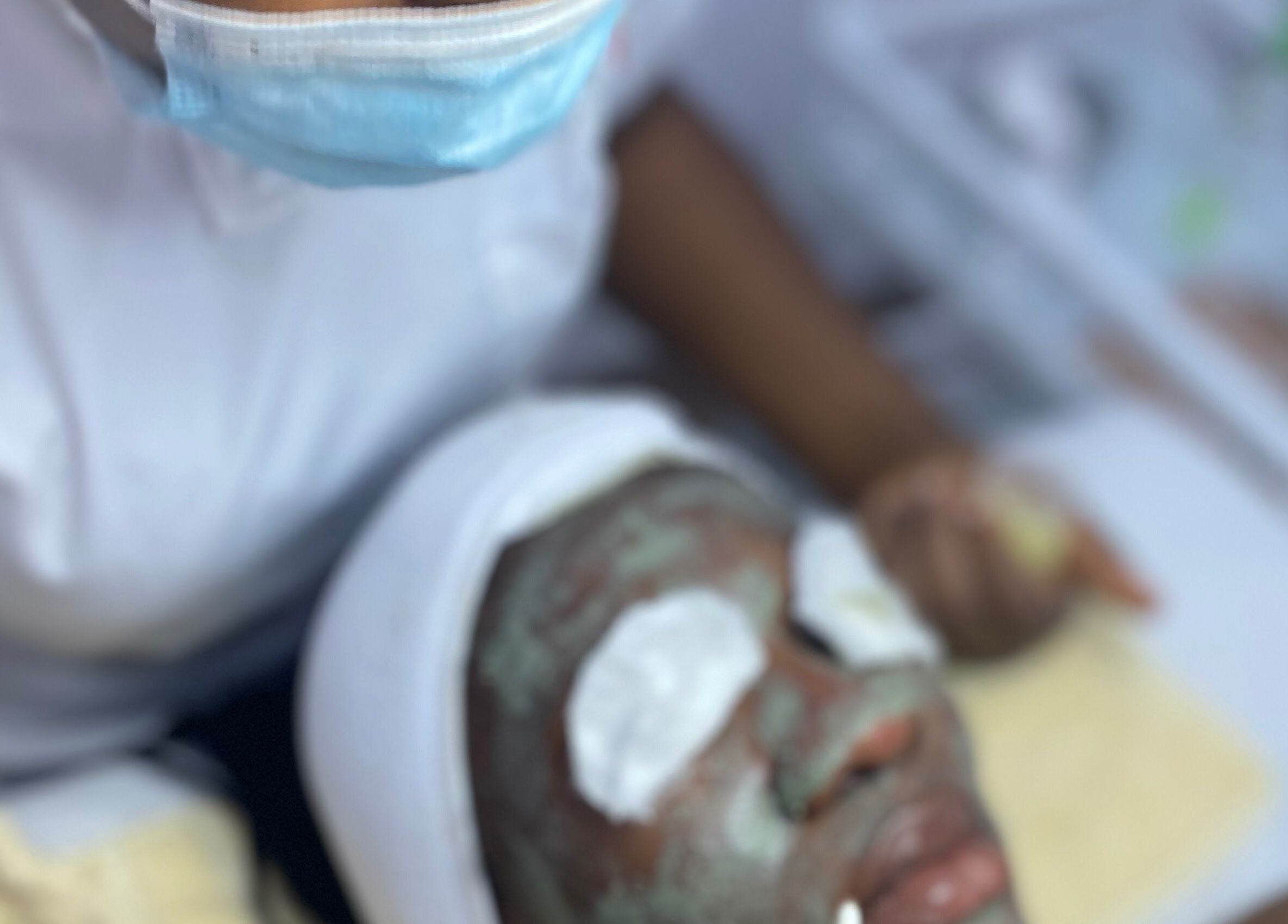 Facial treatment at Frais Esthetics Skincare spa, Lagos, Lagos, NG with mask and eye pads on client.
