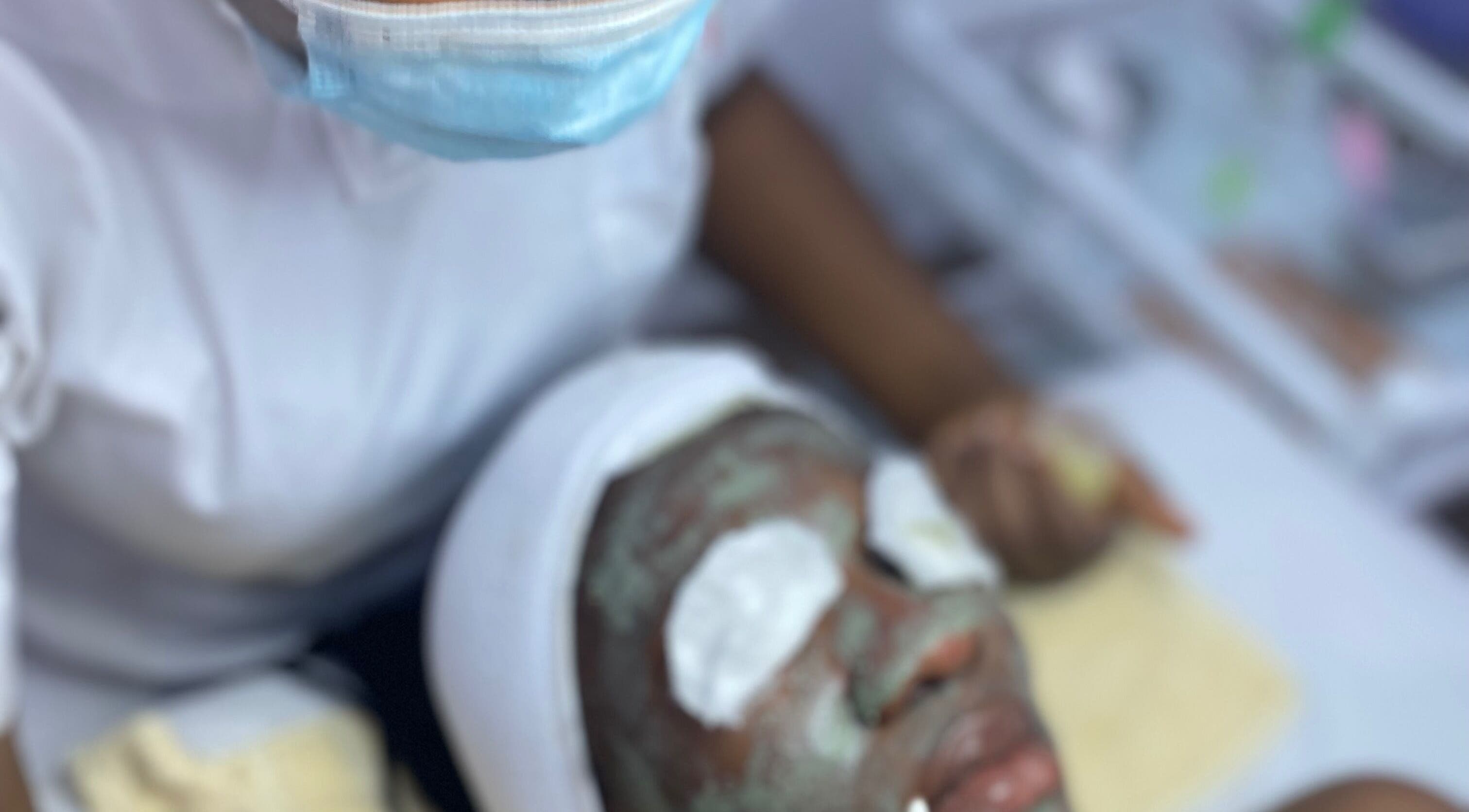 Facial treatment at Frais Esthetics Skincare spa, Lagos, Lagos, NG with mask and eye pads on client.