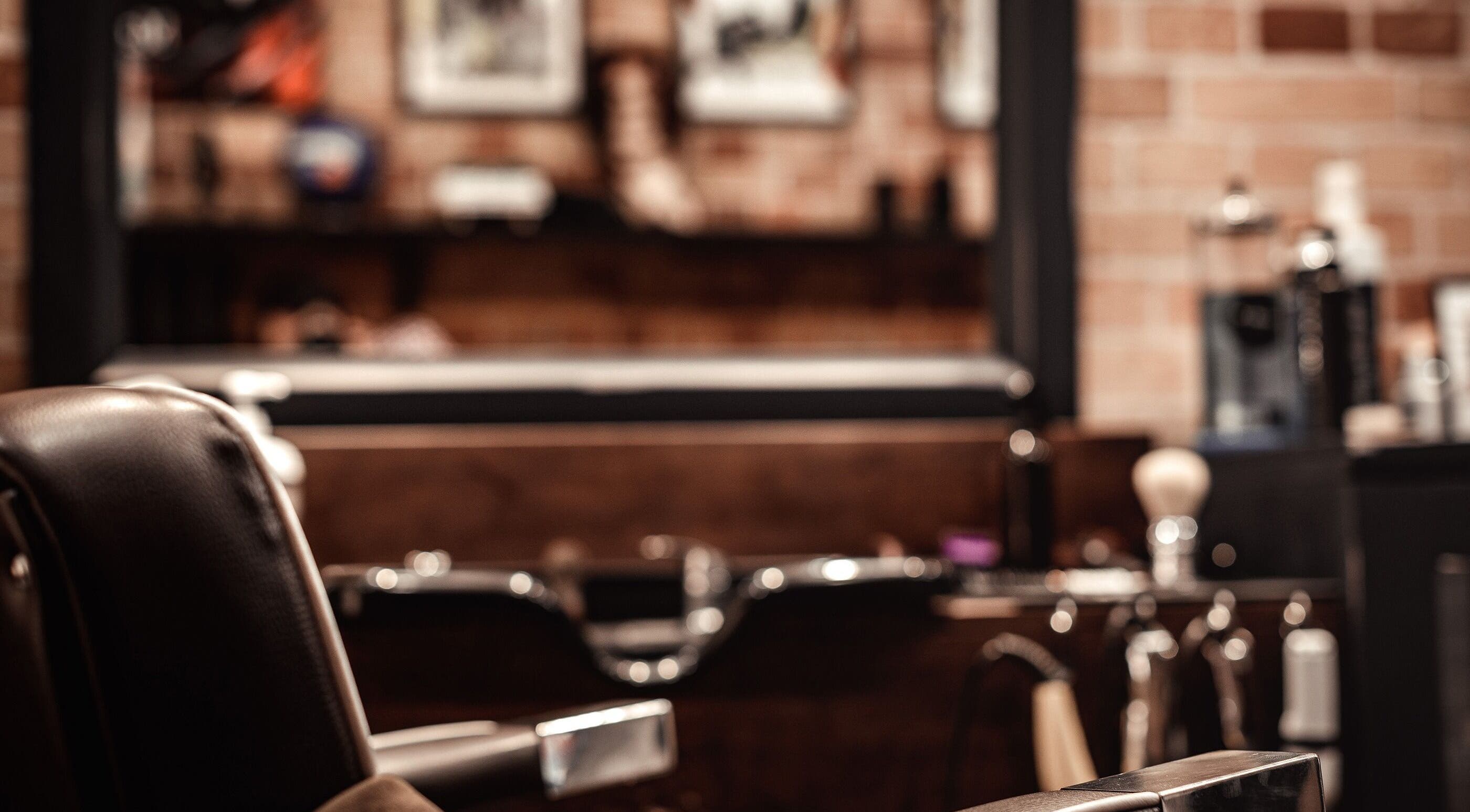 Sophisticated interior of Emilio Barber in Birkirkara, MT with a modern salon chair and elegant decor.