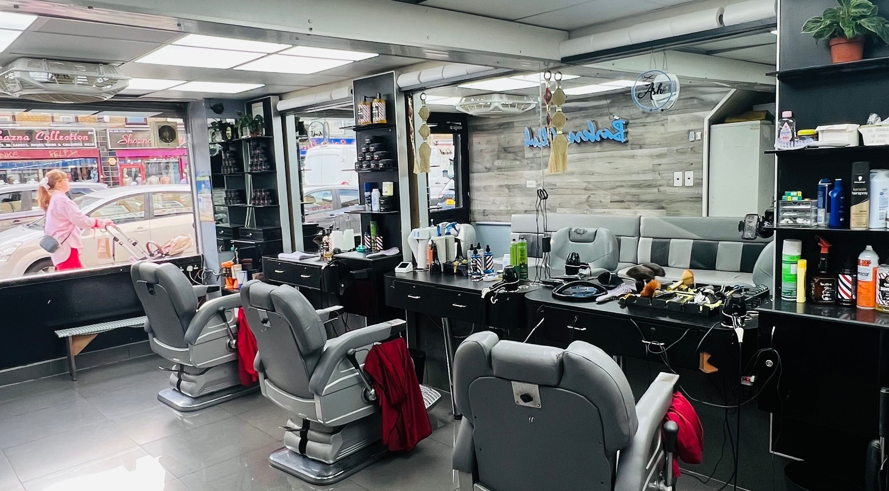Interior of A1 Hair Style salon in London, England, GB with modern styling chairs and mirrors.