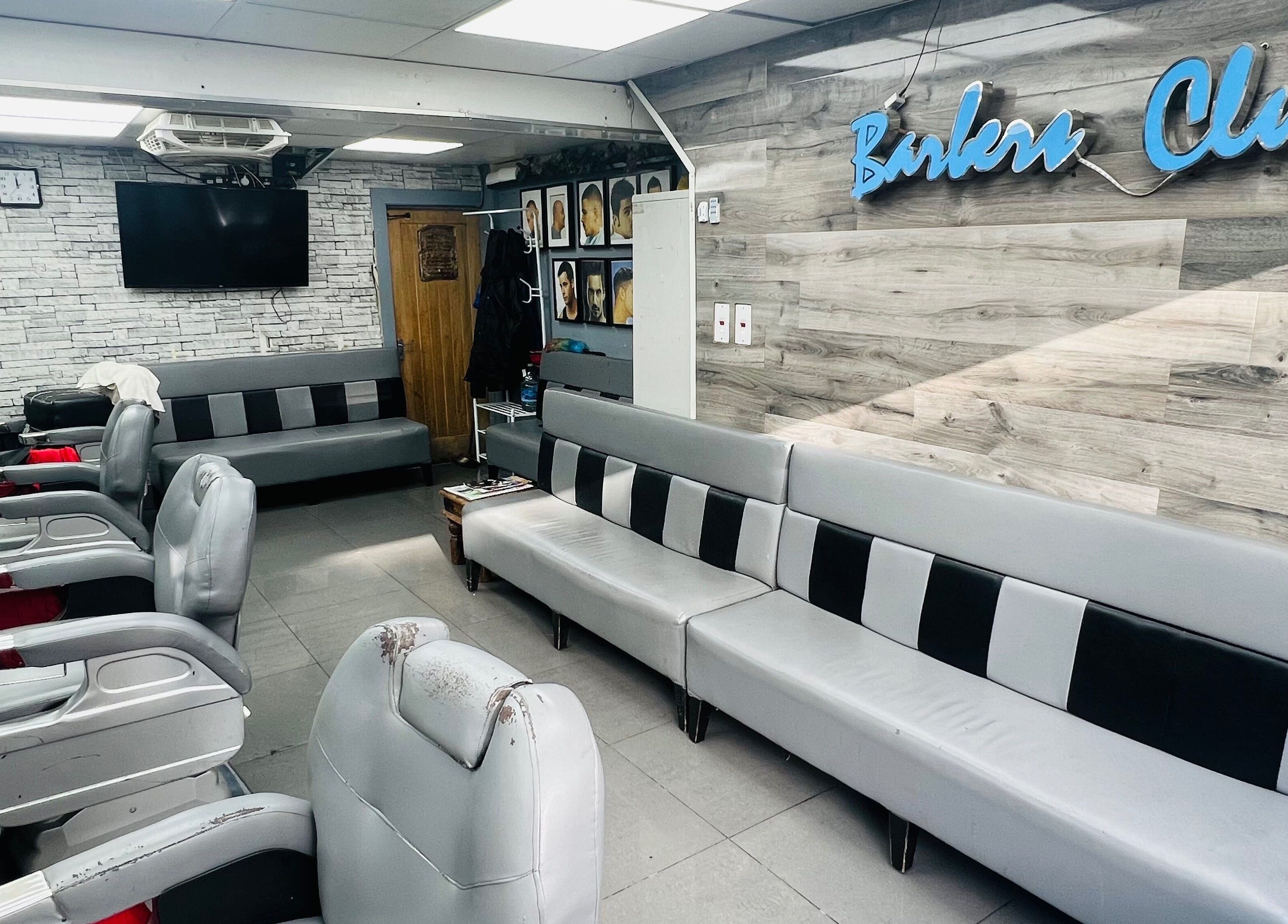 Modern barber interior at A1 Hair Style, showcasing sleek seating, London, England, GB.