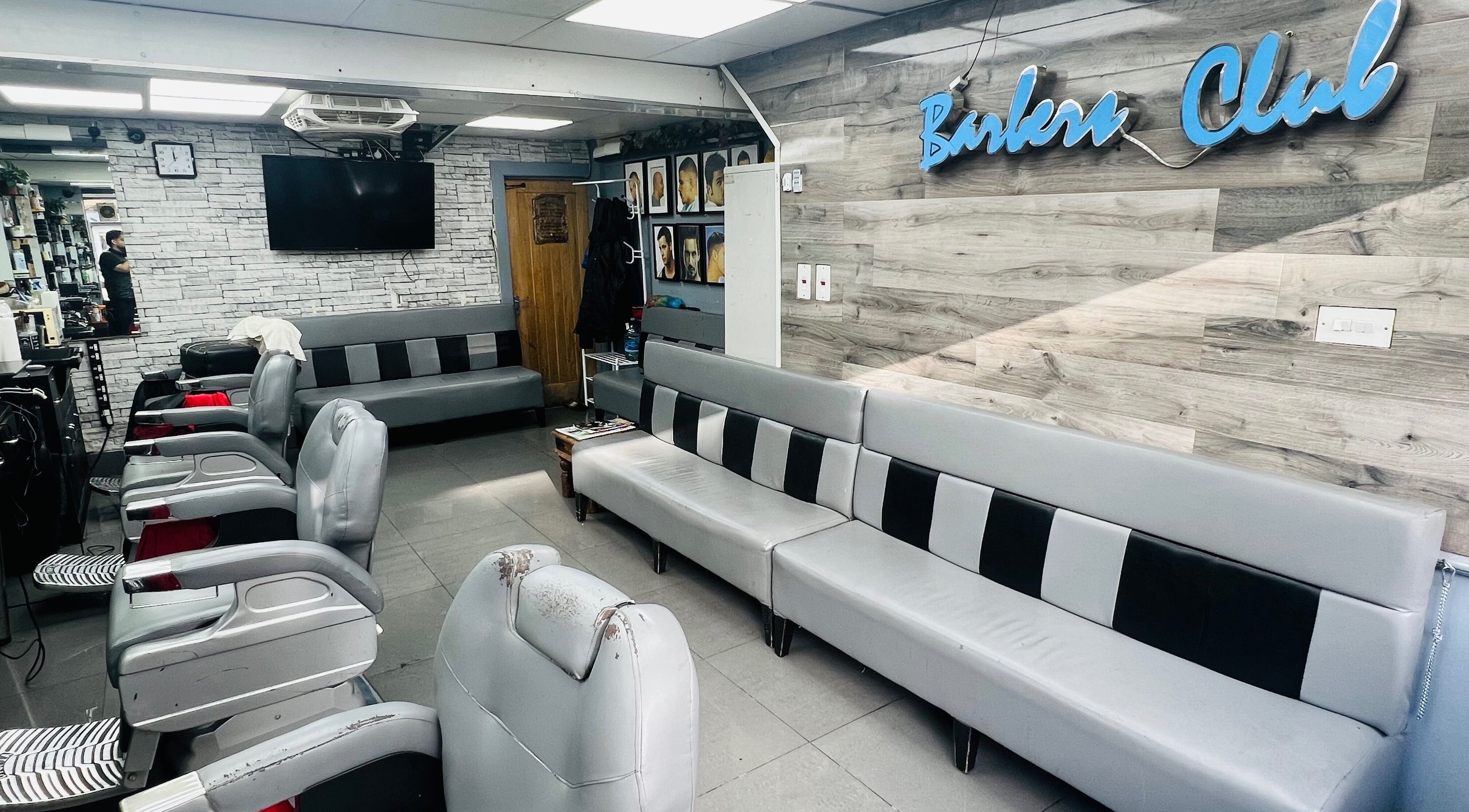 Modern barber interior at A1 Hair Style, showcasing sleek seating, London, England, GB.