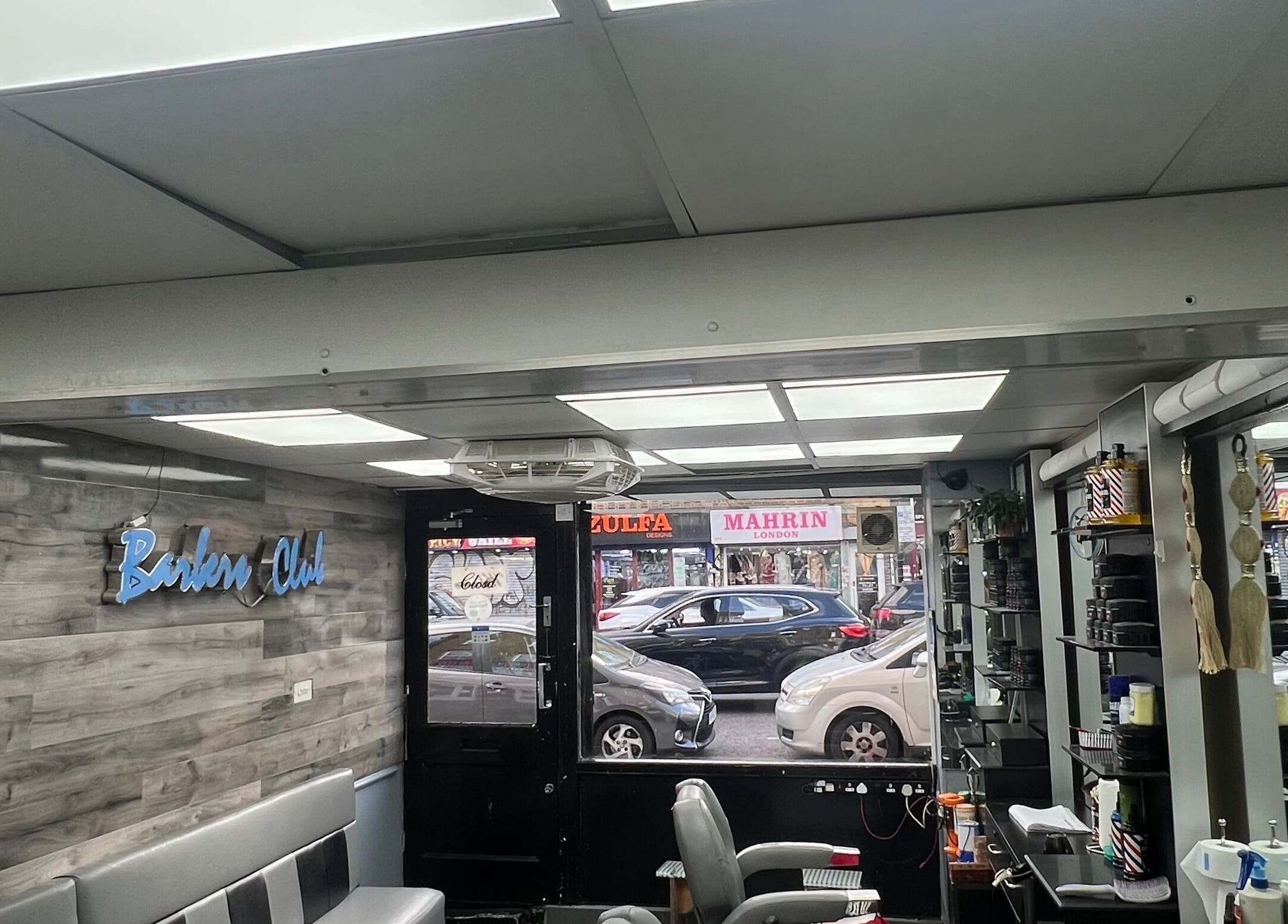 Modern interior of A1 Hair Style in London, England, GB, featuring sleek seating and elegant decor.