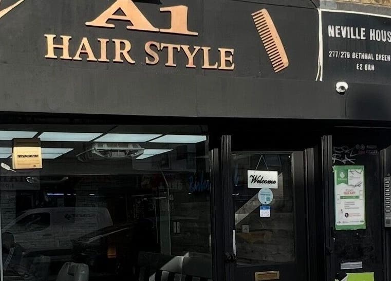 Front view of A1 Hair Style salon in London, England, GB, featuring bold signage.