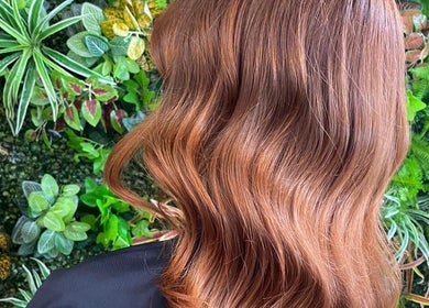 Elegant auburn waves styled at Hair by Elisa Salvatore in Kettering, England, GB, against a lush backdrop.