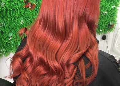 Vibrant red hair styled at Hair by Elisa Salvatore, Kettering, England, GB. Perfect curls and shine.