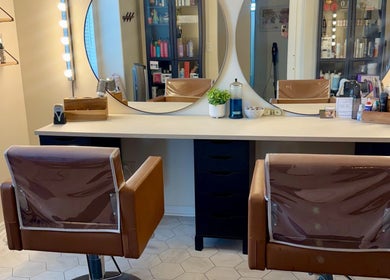 Modern salon chairs and mirrors at Brinley Studio, Lehi, Utah, US. Stylish and inviting beauty venue.