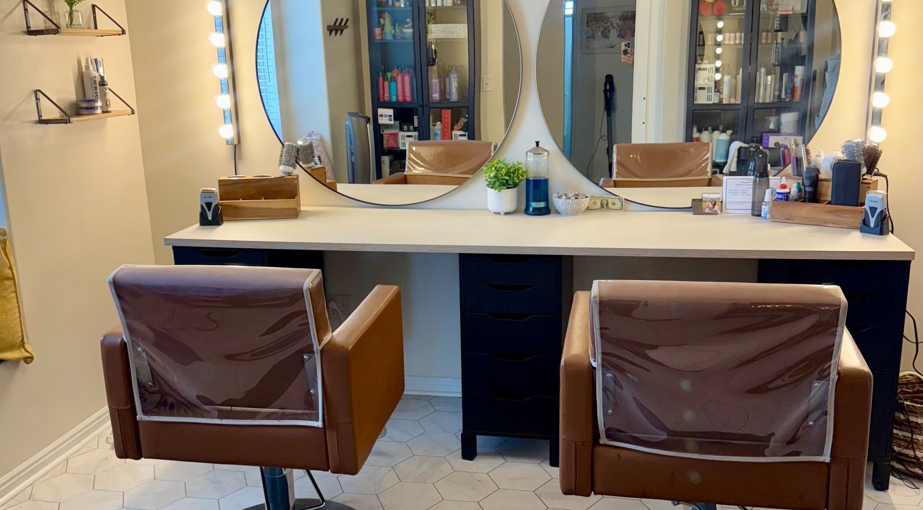 Modern salon chairs and mirrors at Brinley Studio, Lehi, Utah, US. Stylish and inviting beauty venue.