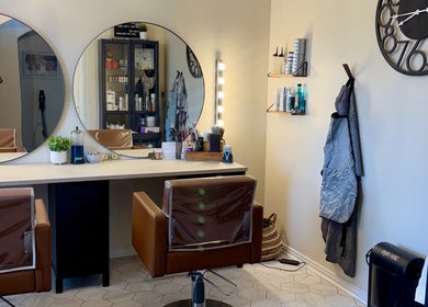 Elegant salon interior at Brinley Studio, Lehi, Utah, US with stylish chairs and mirrors.