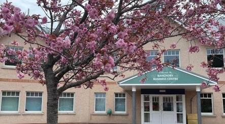 Cherry blossoms adorn Amicorsar-Hairstylist entrance in Banchory, Scotland, GB, adding a serene ambiance.