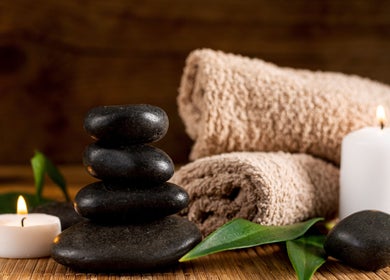 Relaxing spa setup with stones and candles at Ann’s Thai Massage in March, England, GB.