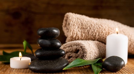 Relaxing spa setup with stones and candles at Ann’s Thai Massage in March, England, GB.