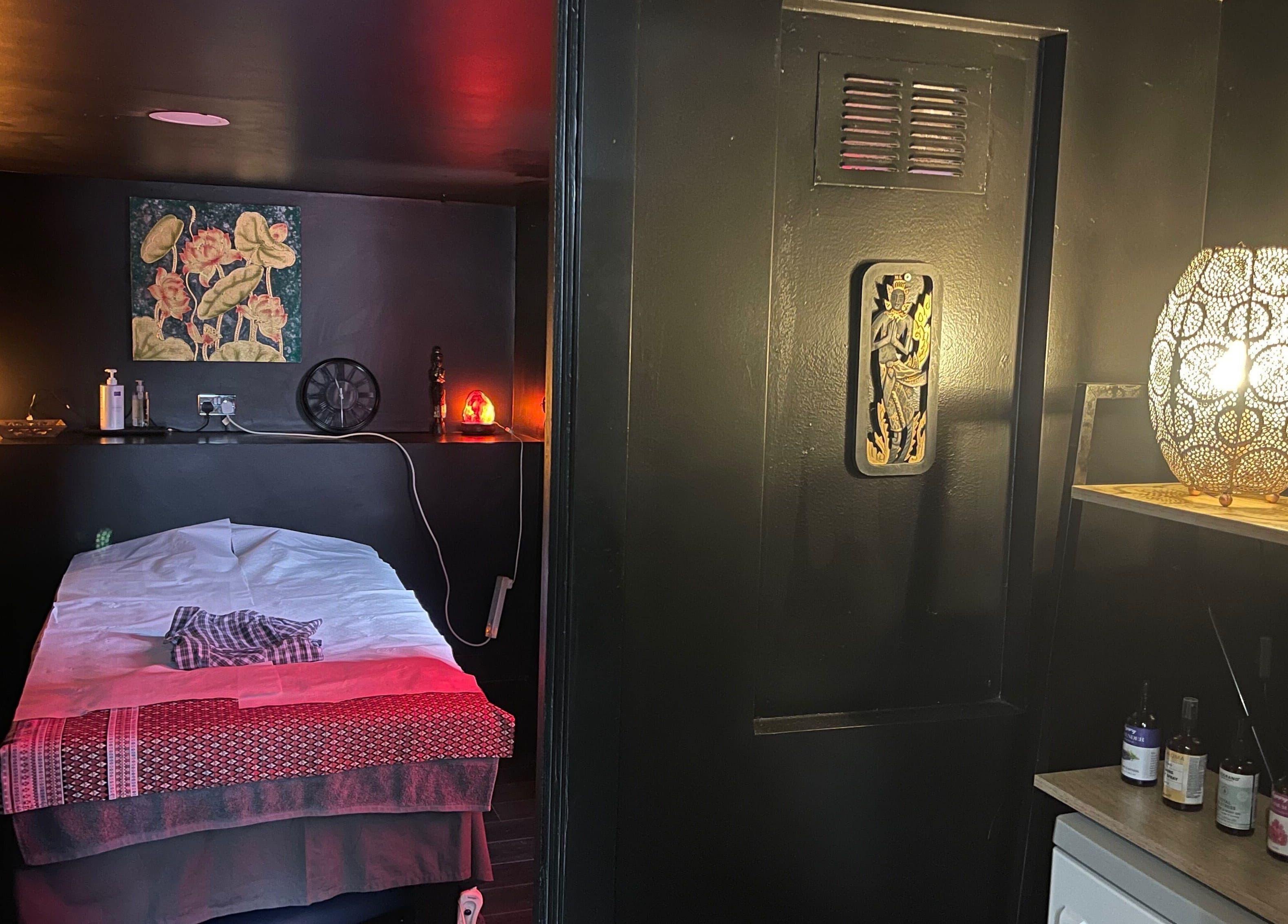 Relaxing massage room at Ann’s Thai Massage, March, England, GB, with warm lighting and elegant decor.