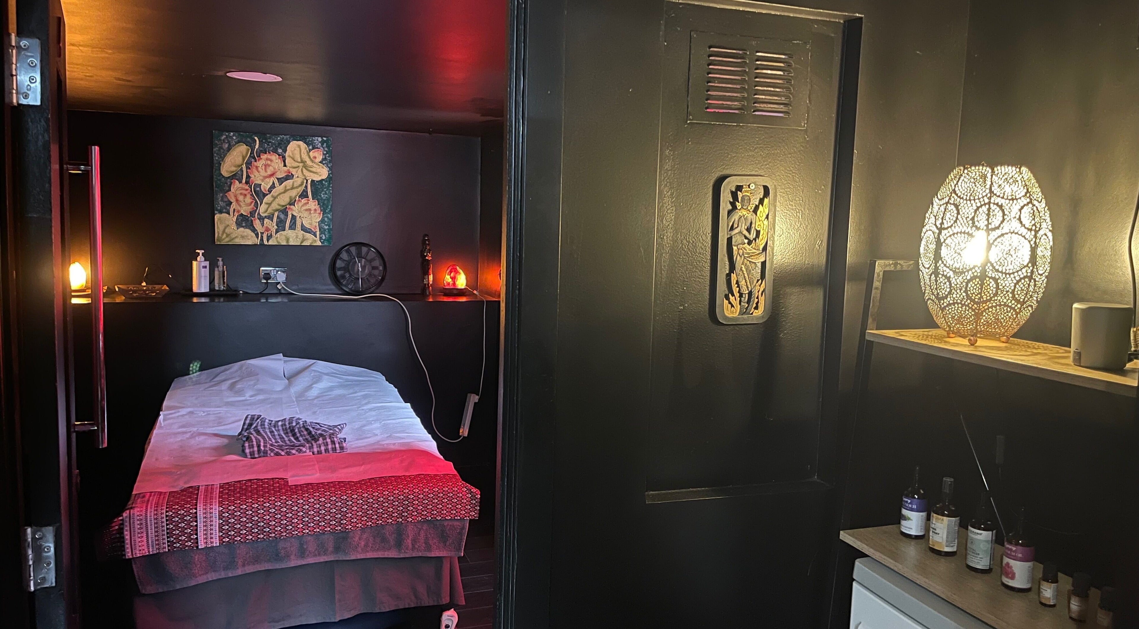 Relaxing massage room at Ann’s Thai Massage, March, England, GB, with warm lighting and elegant decor.